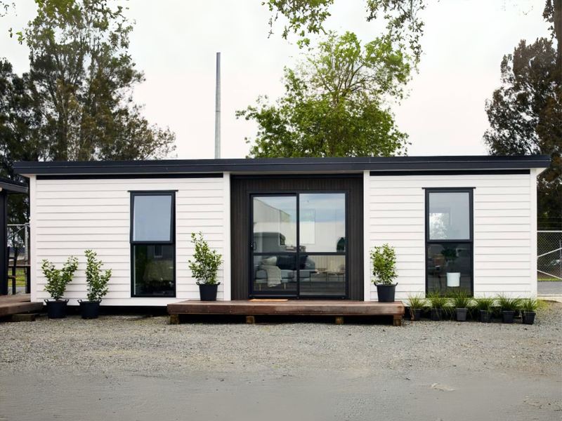 A Tiny Home Base transportable home placed on a rural site